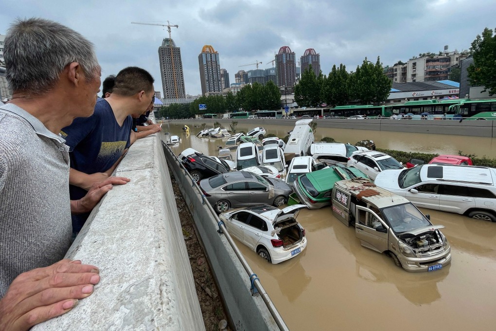 Zhengzhou residents survey the aftermath of the floods on Wednesday. Photo: STR/AFP