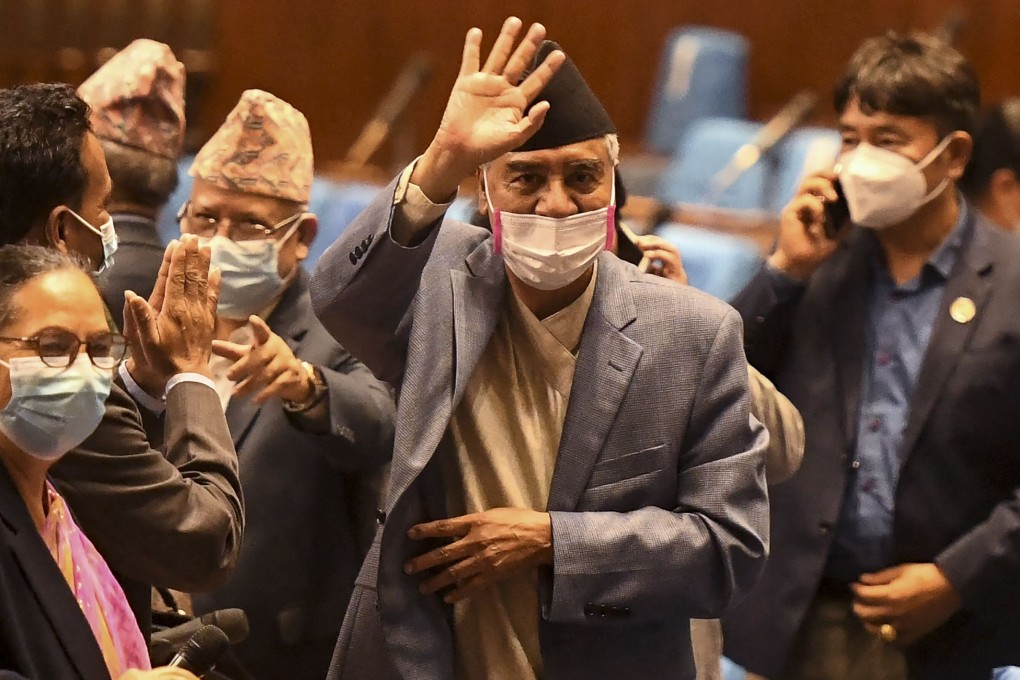 Nepal's newly appointed Prime Minister Sher Bahadur Deuba, centre, waves after winning a vote of confidence in Kathmandu on July 18. Photo: AFP