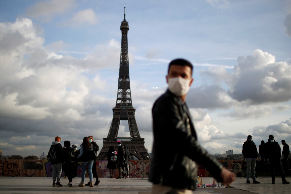 A man wears a protective face mask at Trocadero square near the Eiffel Tower in Paris. Photo: Reuters