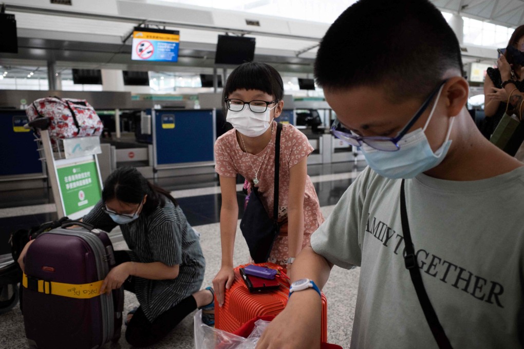 A family check their luggage before boarding a flight from Hong Kong to the UK. Photo: AFP
