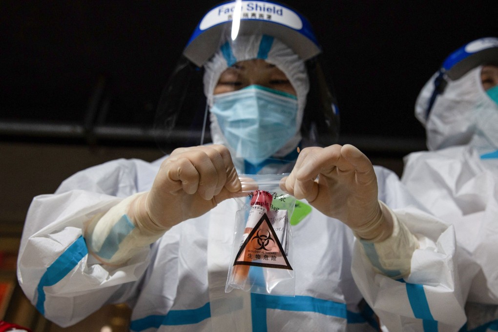 A medical worker collects a sample for testing in Nanjing, where mass screening is under away amid a new outbreak. Photo: AFP