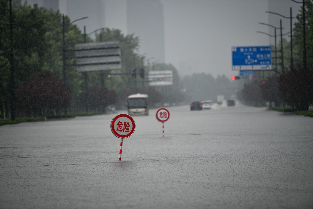 Danger signs on a waterlogged road in Zhengzhou, capital of central China‘s Henan Province, on July 20, 2021. Photo: Xinhua