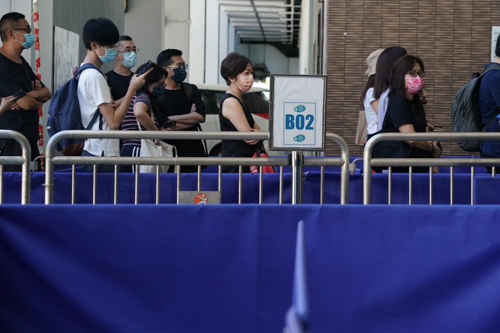People wait to receive the BioNTech Covid-19 vaccine at a centre in Sai Ying Pun. Photo: Felix Wong