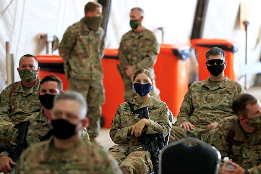 US soldiers wearing protective masks during a handover ceremony of Taji military base from US-led coalition troops to Iraqi security forces in Baghdad, Iraq in August 2020. Photo: Reuters
