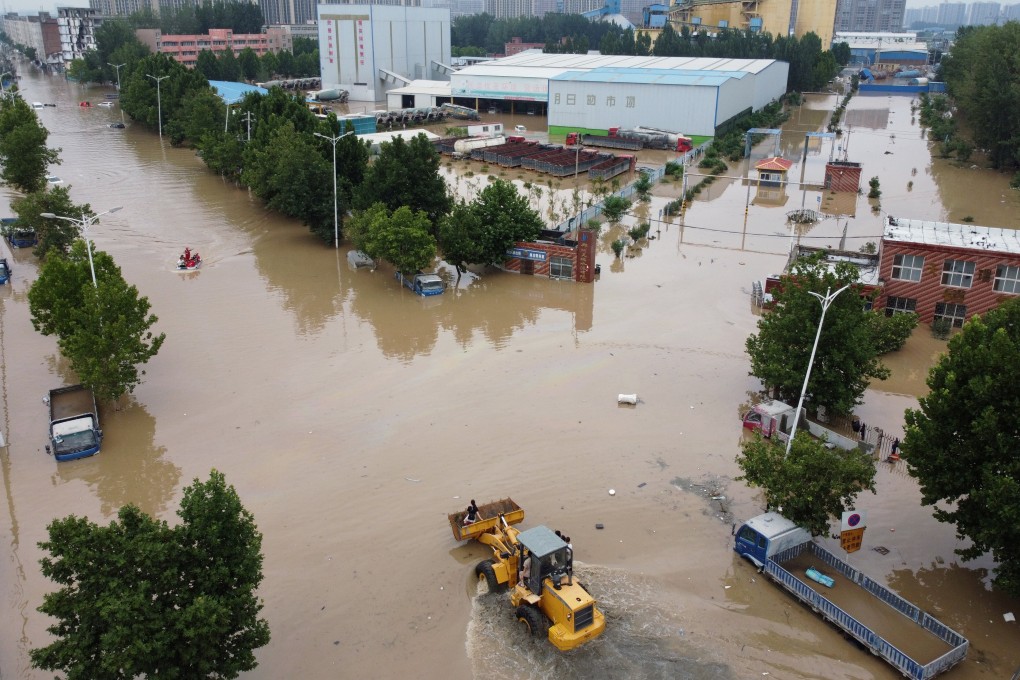 Rescue workers evacuate residents on a flooded road following a heavy rainfall in Zhengzhou. Photo: Reuters