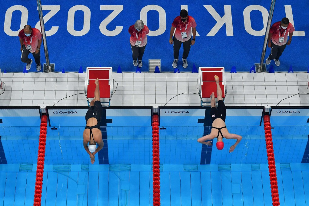 Olivia Smoliga (left), of the US, and Britain's Lucy Hope compete in the women's 4x100m freestyle relay at the Tokyo Aquatics Centre. Photo: AFP