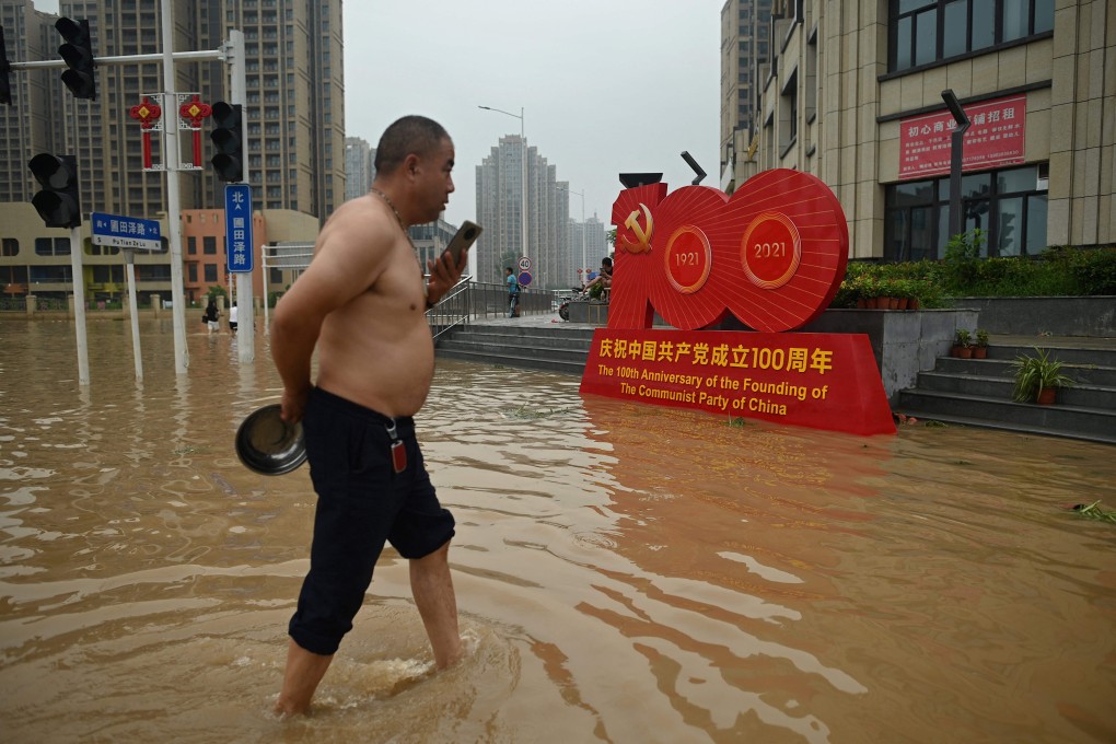 A resident wades through a flooded street in Zhengzhou, Henan province on Friday. Photo: AFP