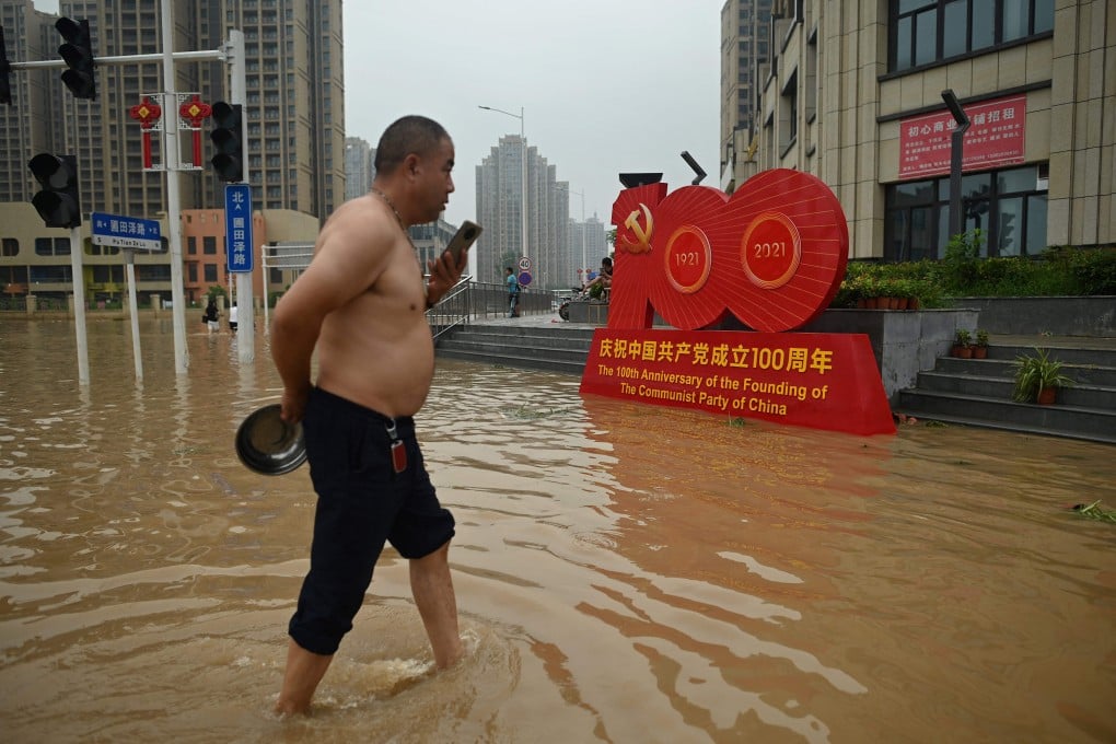 A resident wades through a flooded street in Zhengzhou, Henan province on Friday. Photo: AFP