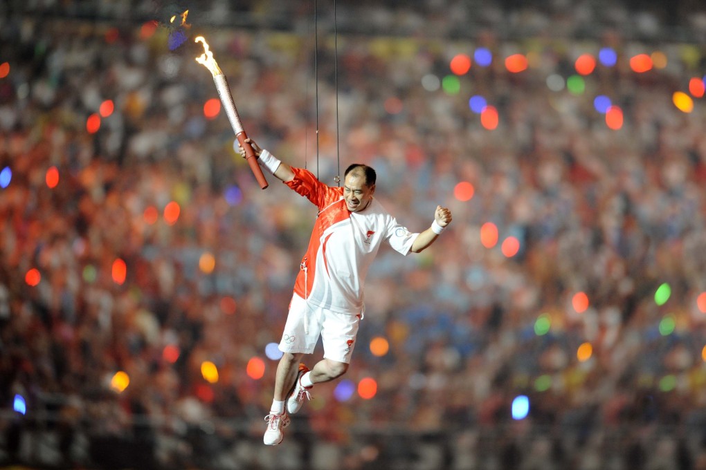 Former Chinese gymnastics champion Li Ning ‘runs’ around the inside of the National Stadium, known as the Bird’s Nest, at the spectacular opening to the 2008 Beijing Olympics. Photo: Xinhua
