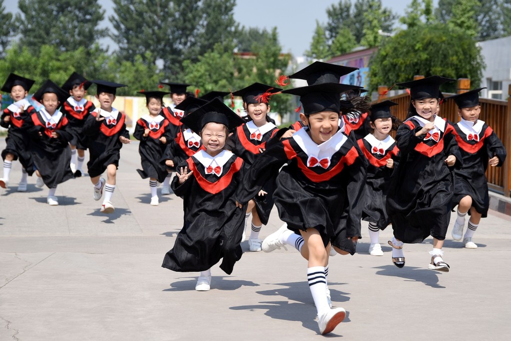 Children in gowns and mortar boards during their kindergarten graduation ceremony in Handan, Hebei province on June 20, 2017. Photo: China Daily via Reuters