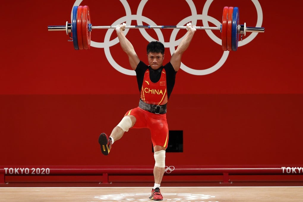 Chinese weightlifting gold medallist Li Fabin in the men's 61kg snatch group at the Tokyo 2020 Olympic Games at the Tokyo International Forum in July. Photo: EPA