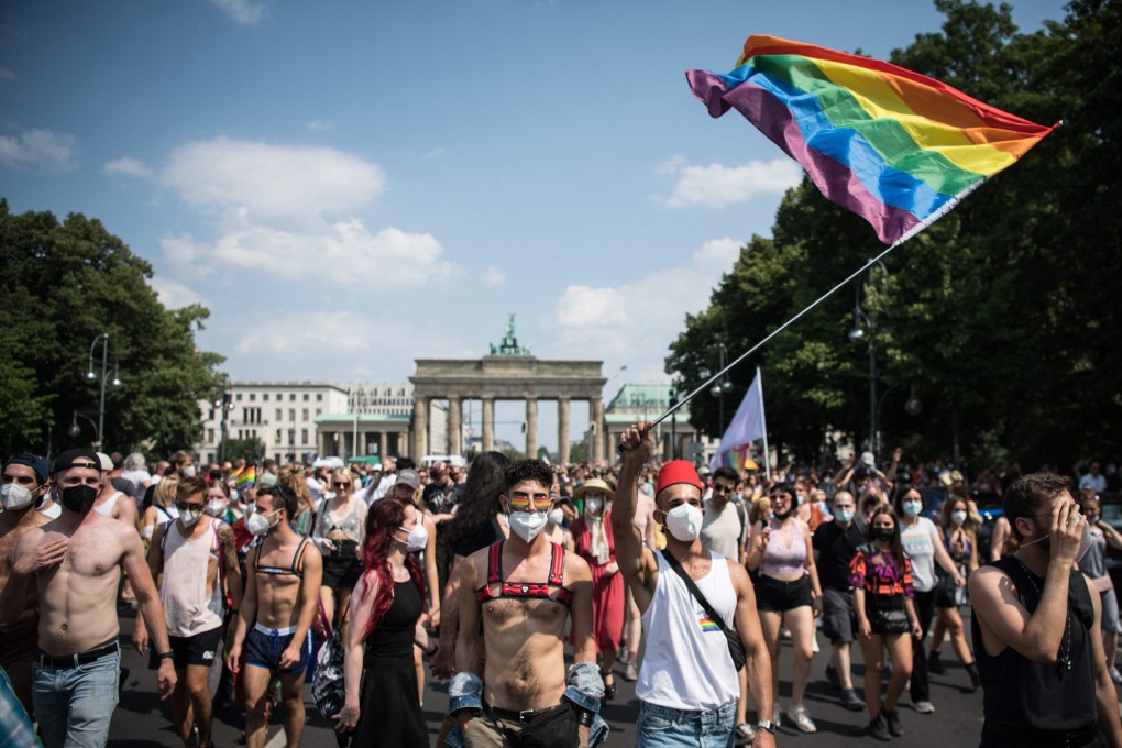 Participants take part in the annual Christopher Street Day parade with the motto ‘Save Our Community- Save Your Pride’ in front of Brandenburg Gate in Berlin, Germany on Saturday. Photo: AFP