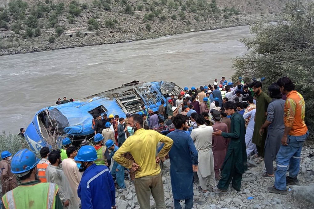 Rescuers and onlookers gather around the wreck of a bus in Pakistan which plunged into a ravine on July 14 following an explosion, killing 13, nine of whom were Chinese workers. Photo: AFP
