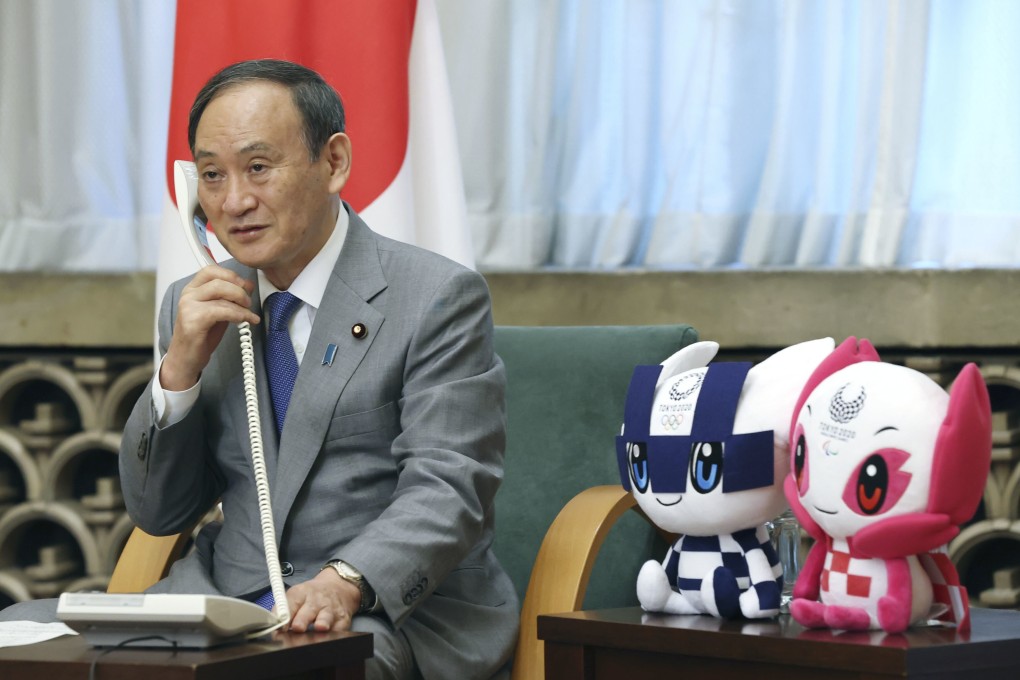 Japanese Prime Minister Yoshihide Suga speaks on the phone with judo gold medallist Naohisa Takato on Sunday. Suga’s approval rating is at the lowest point since he took office last September. Photo: Kyodo