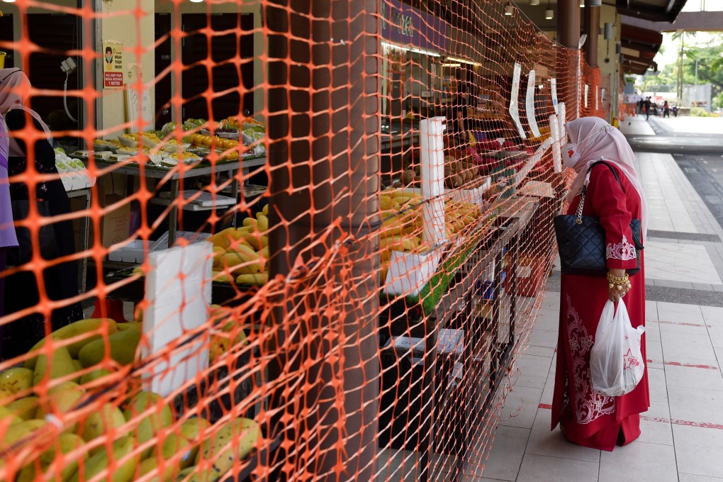 A wet market in Singapore is cordoned off to limit entry and exit points. Photo: Reuters