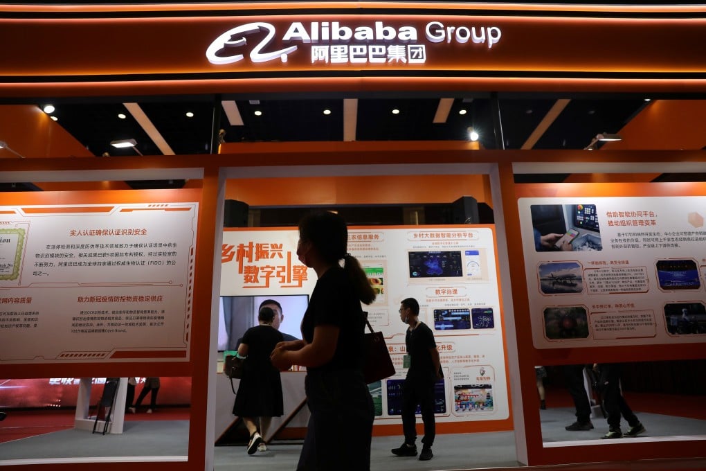 People walk past a booth of Alibaba Group at an exhibition during the China Internet Conference in Beijing, China on July 13, 2021. Photo: SCMP