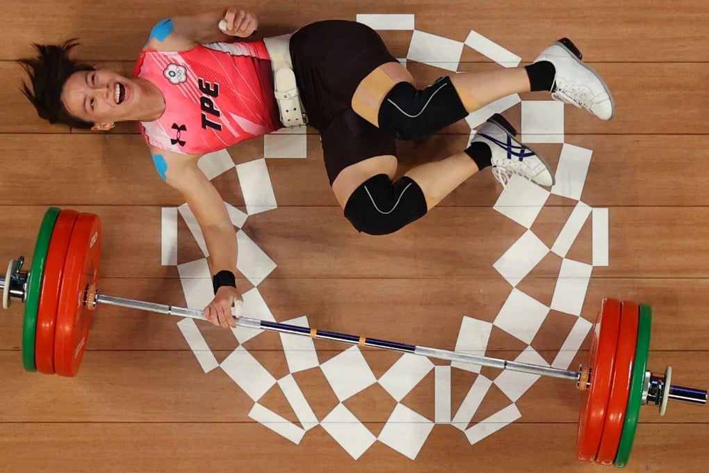 Kuo Hsing-chun falls to the floor in the women’s 59kg weightlifting competition. Photo: AFP