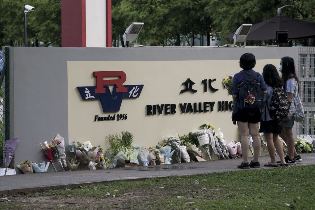 Flowers and mourners at the entrance of the River Valley High School in Singapore on July 21. Photo: EPA