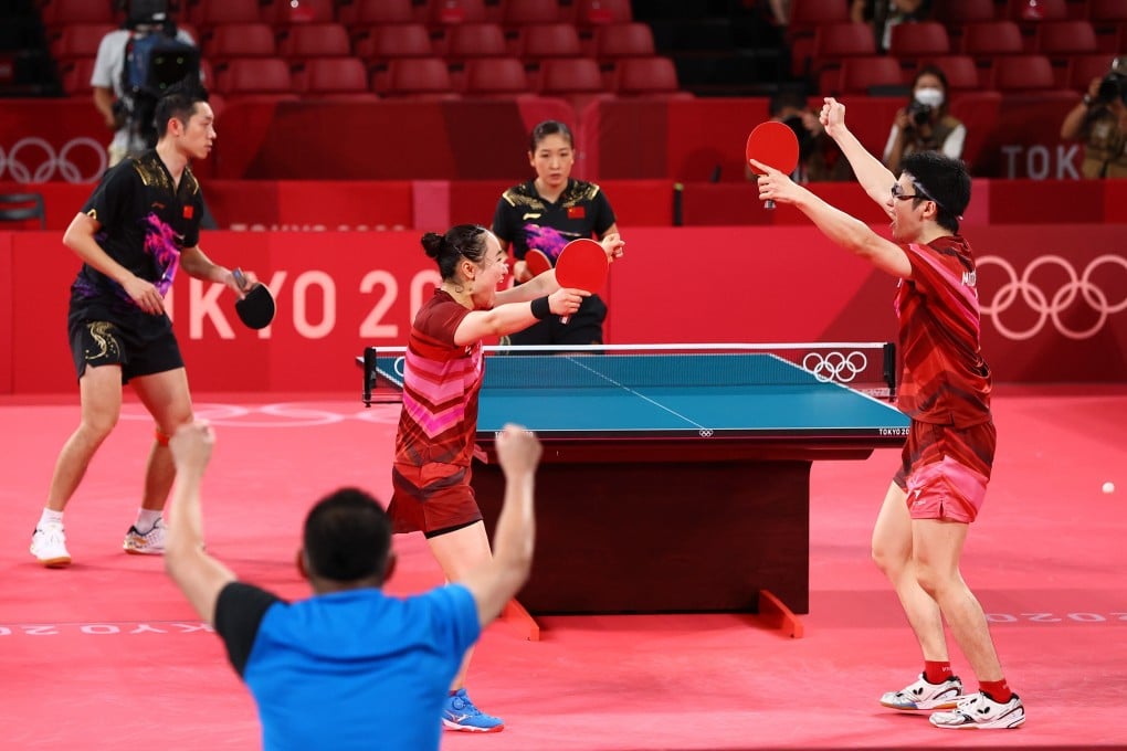 Japans’s Mima Ito and Jun Mizutani celebrate winning their gold medal mixed doubles match against China’s Xu Xin and Liu Shiwen. Photo: Reuters