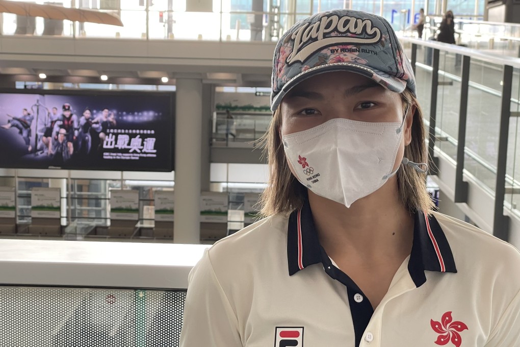 Sarah Lee leaves for Tokyo confident of winning medals in the keirin and sprint. The background shows a poster of Hong Kong athletes at the airport. Photo: Chan Kin-wa
