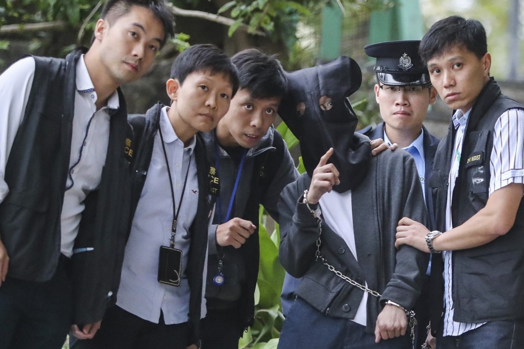 Police officers escort Lai Kan-yau to Waterfall Bay while investigating the murder of his father. Photo: Edward Wong