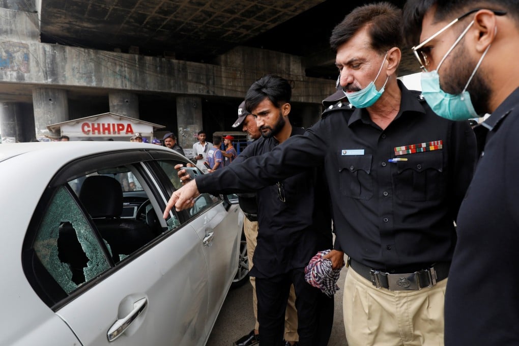 A police officer surveys the site after gunmen on a motorcycle opened fire on a vehicle belonging to a Chinese national in Karachi, Pakistan on Wednesday. Photo: Reuters