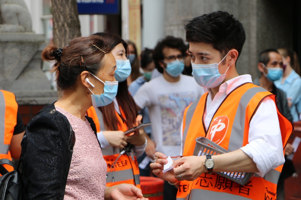 People queue for coronavirus vaccine shots in London's Chinatown on Monday. Photo: Hilary Clarke