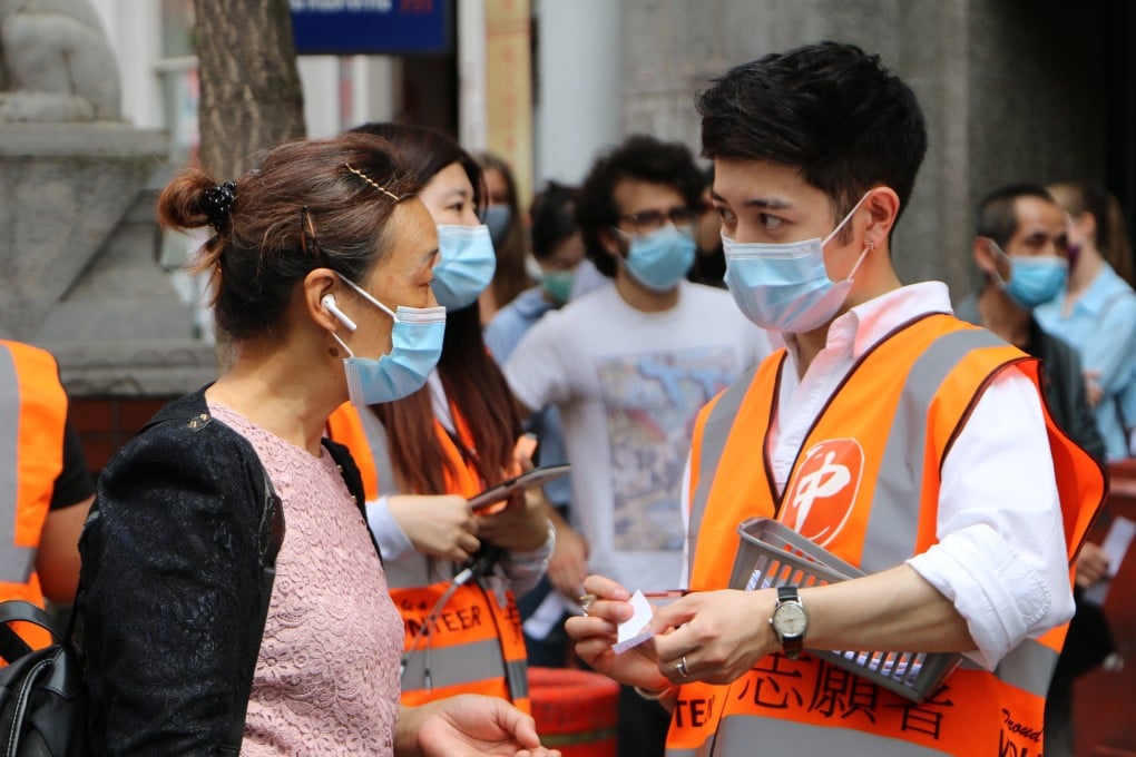 People queue for coronavirus vaccine shots in London's Chinatown on Monday. Photo: Hilary Clarke