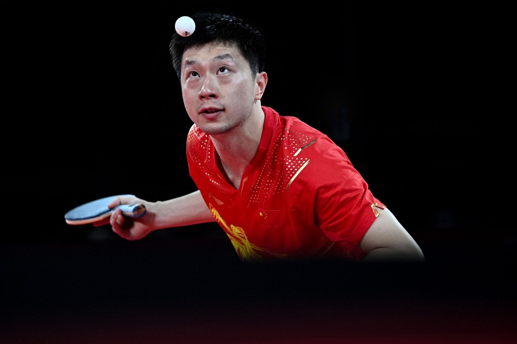 China's Ma Long serves to Germany's Dimitrij Ovtcharov at Tokyo 2020. Photo: AFP