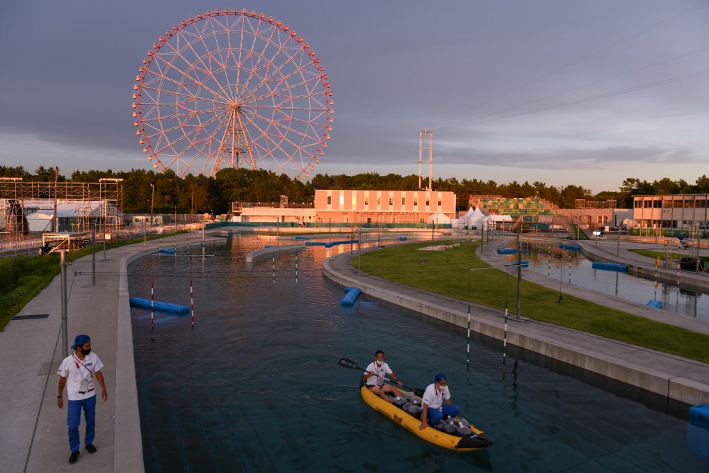 Olympic staff members clean a course at Kasai Canoe Slalom Centre in Tokyo. Photo: Bloomberg