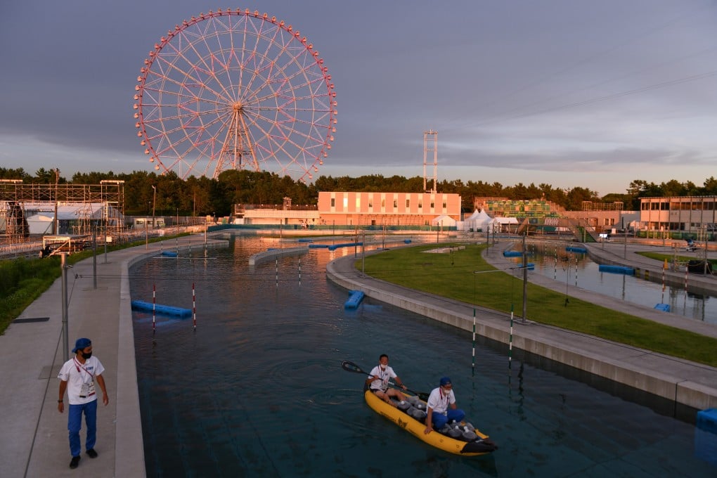 Olympic staff members clean a course at Kasai Canoe Slalom Centre in Tokyo. Photo: Bloomberg