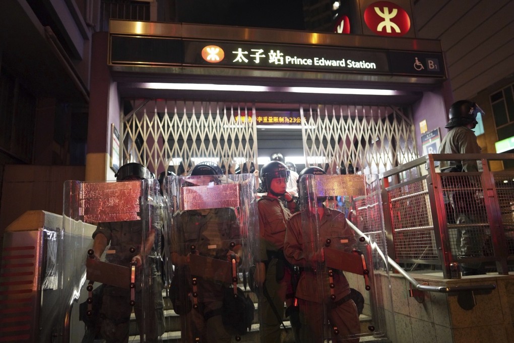 Police stand guard as protesters are arrested at Prince Edward MTR station on August 31, 2019. Photo: AP