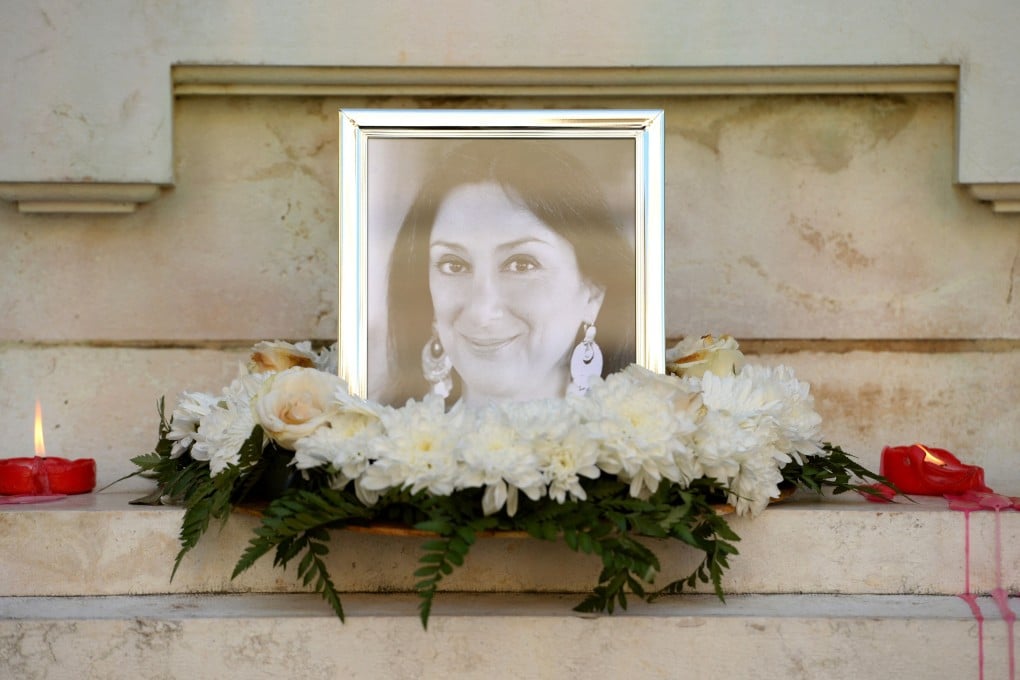 Flowers and tributes lie at the foot of the Great Siege monument in Valletta, which was turned into a temporary shrine for Maltese journalist Daphne Caruana Galizia after she was killed by a car bomb in October 2017. Photo: AFP