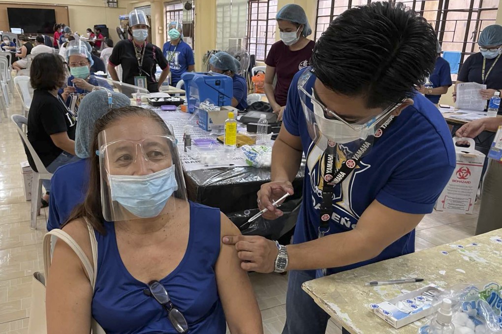 A Philippines resident being inoculated with the AstraZeneca vaccine. photo: AP