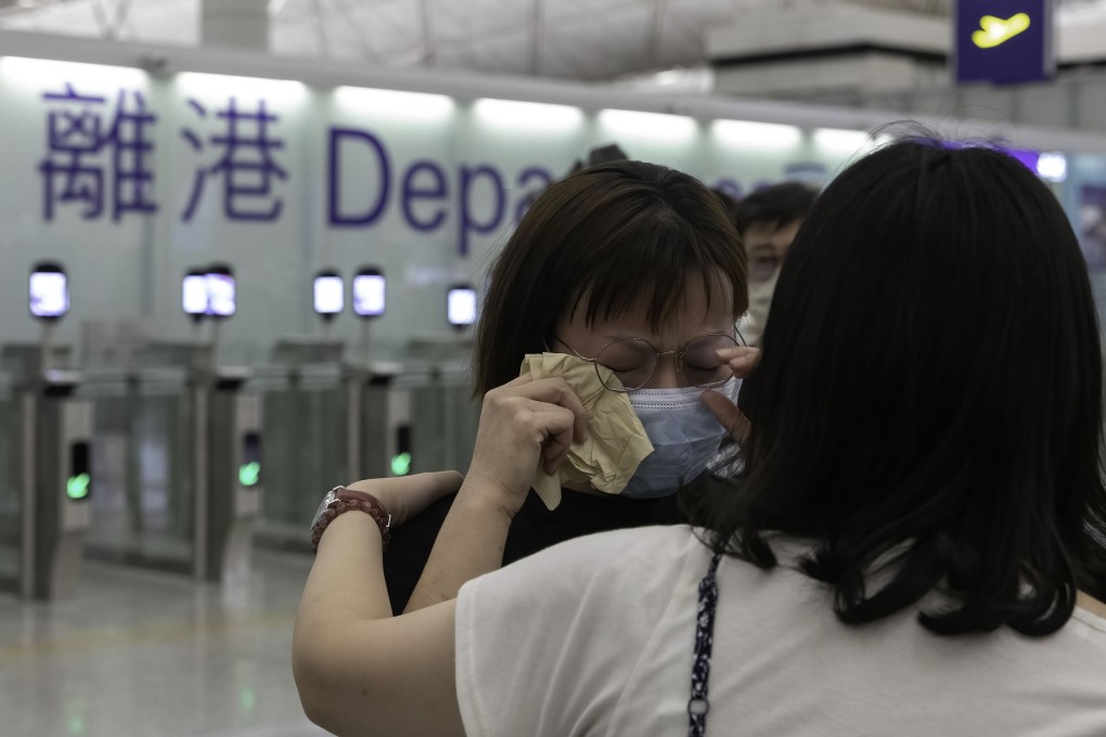 A woman weeps as she says goodbye to a friend at Hong Kong’s airport. Photo: DPA