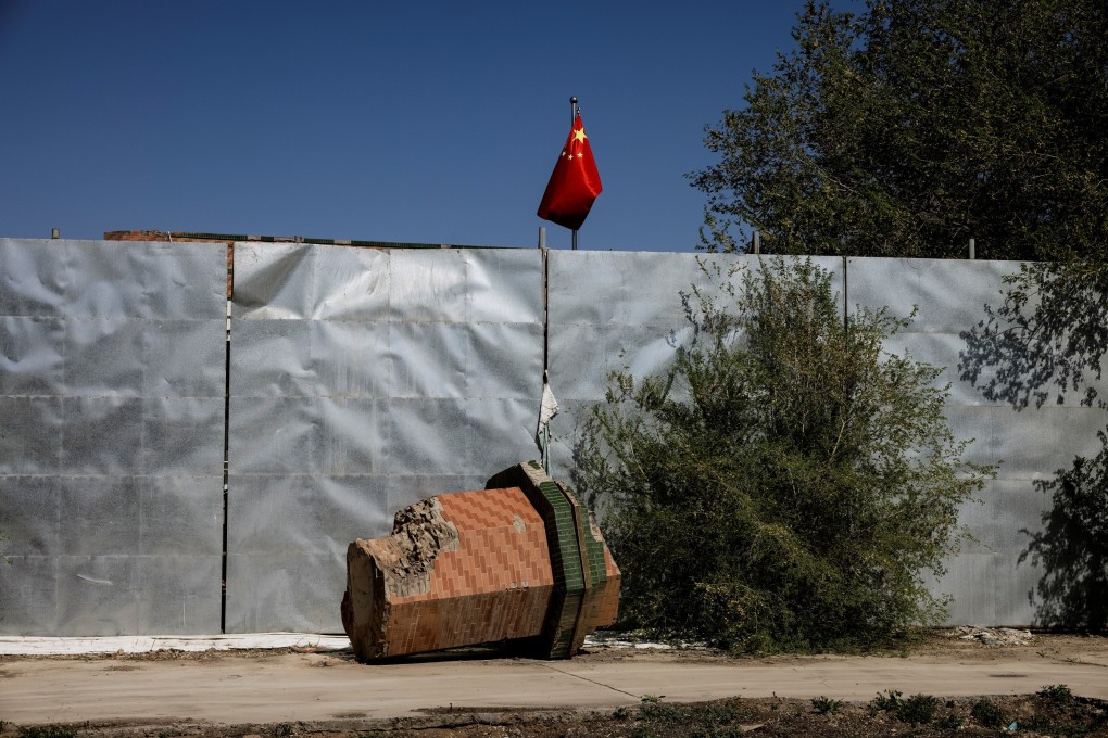 A broken-off minaret from the Xinqu Mosque lies near a Chinese national flag in Changji outside Urumqi, in China’s Xinjiang Uygur autonomous region, in May. Photo: Reuters