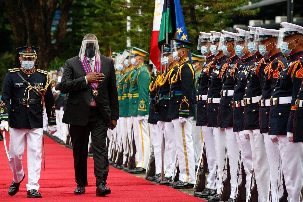US Defence Secretary Lloyd Austin walks past military honour guards in Manila on Friday. Photo: AFP
