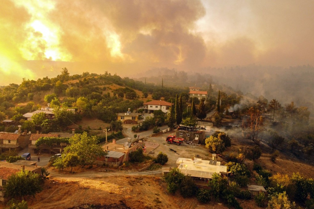 Houses surrounded by a fire which engulfed a Mediterranean resort region on Turkey’s southern coast near the town of Manavgat on Friday. Photo: AFP