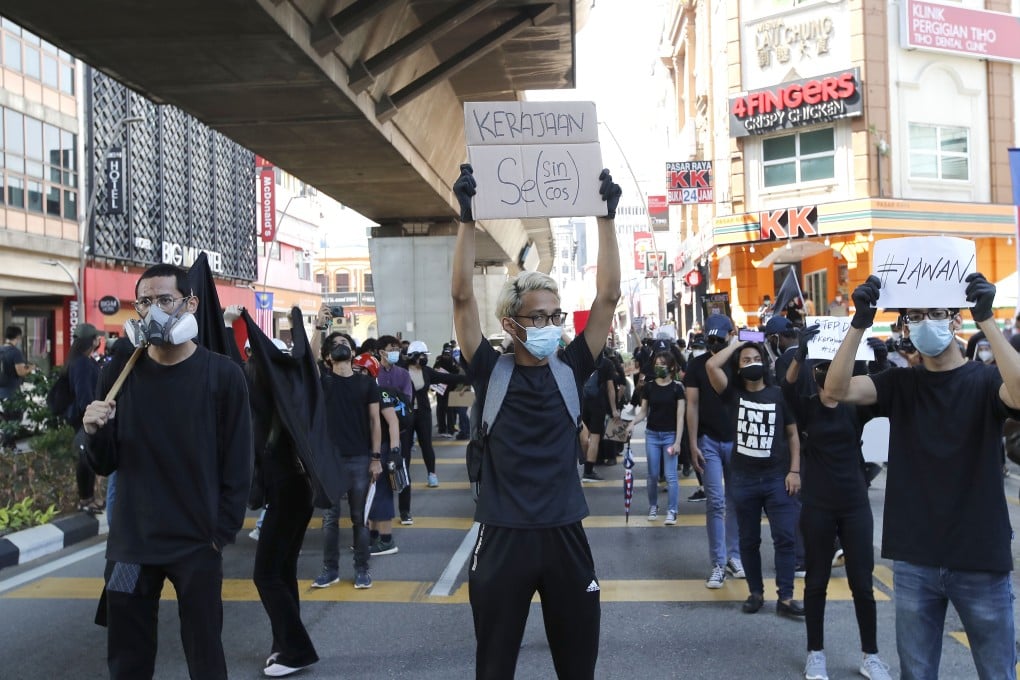 Malaysian protesters hold placards during a demonstration in Kuala Lumpur on Saturday. Photo: AP