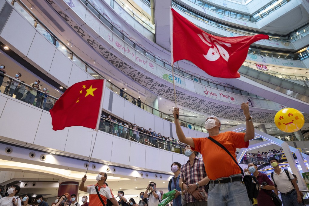 People watch a live broadcast of the Tokyo 2020 Olympic Games in Hong Kong, on July 30, 2021. Photo: EPA-EFE