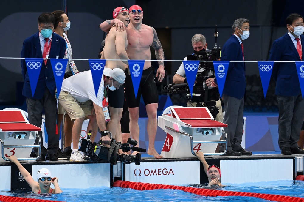 Britain’s James Guy and Adam Peaty celebrate setting a new world record to take gold in the final of the mixed 4x100m mixed medley relay at the Tokyo Olympics. China’s Junxuan Yang and Britain’s Anna Hopkin look at the times after touching the wall. Photo: AFP
