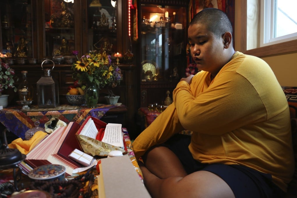 Jalue Dorje, 14, says his morning prayers in Columbia Heights. Photo: AP