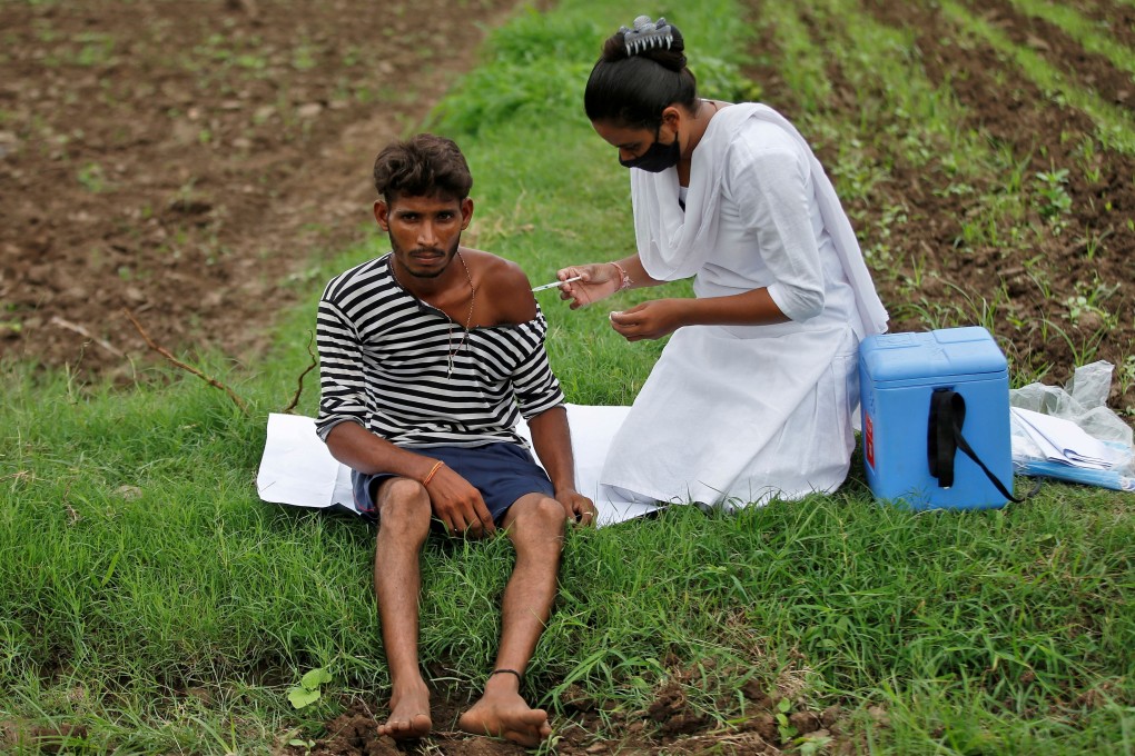 A health worker administers a Covid-19 vaccine dose to a farmer in Gujarat. Photo: Reuters