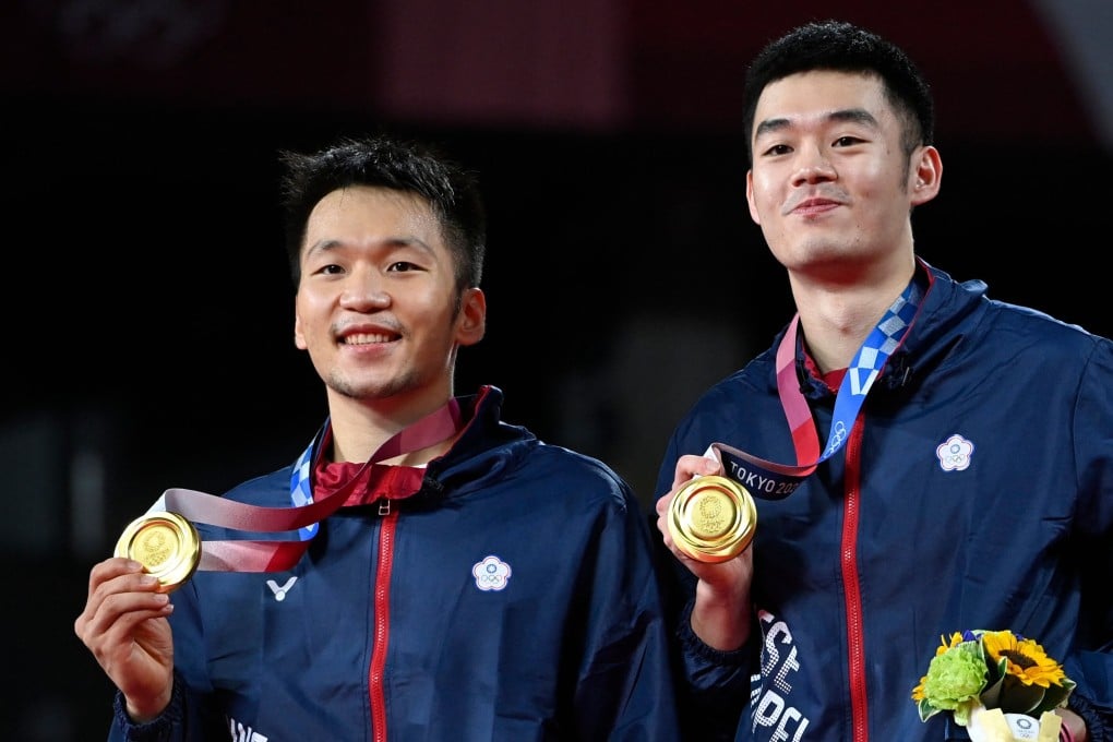 Taiwan's Lee Yang (left) and Wang Chi-lin pose with their men's doubles badminton gold medals at a ceremony during the Tokyo 2020 Olympic Games at the Musashino Forest Sports Plaza. Photo: AFP