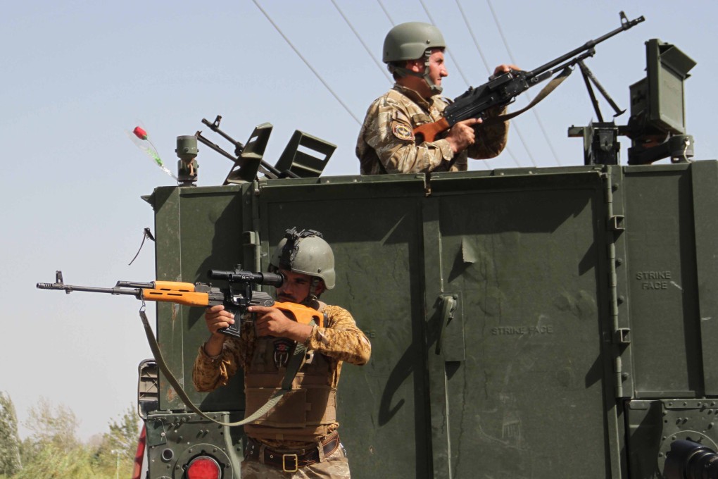Afghan security officials stand guard at a roadside check point in Herat, Afghanistan on Saturday. Photo: EPA-EFE