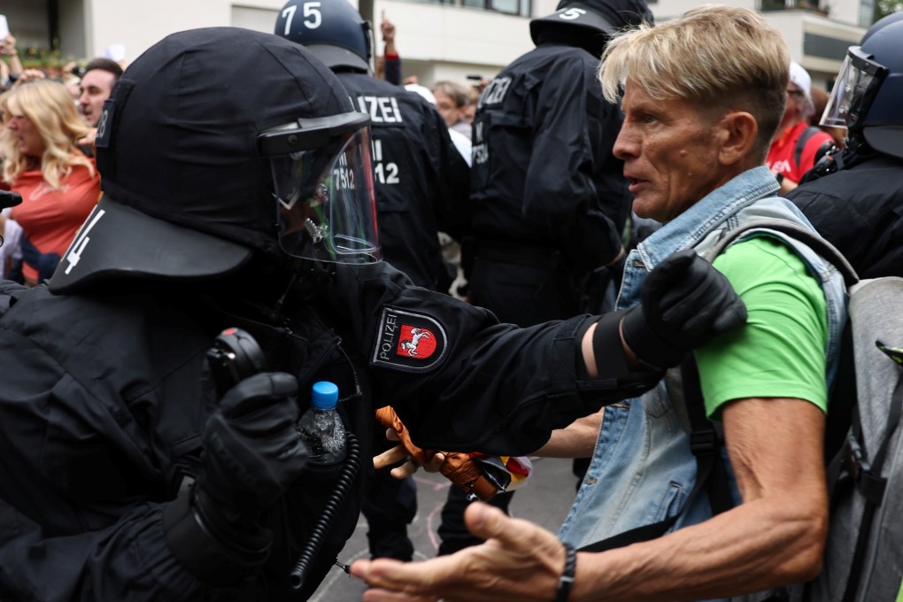 Police scuffle with a demonstrator in Berlin. Photo: Reuters