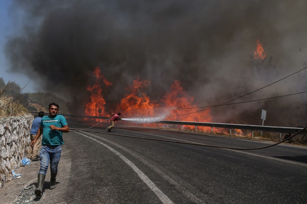 Firefighters try to put out fires in the Marmaris district of Mugla, Turkey on Sunday. Photo: EPA-EFE
