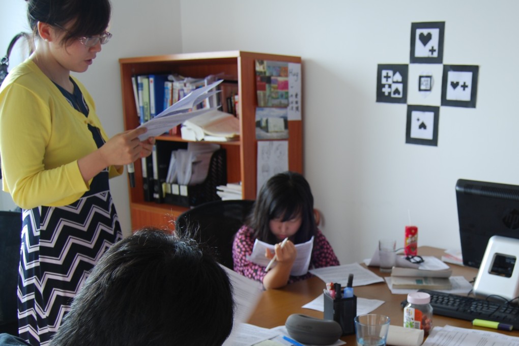 A teacher (standing) is tutoring students, all from rich families, on English at a private institute in Shanghai. Photo: Alice Yan