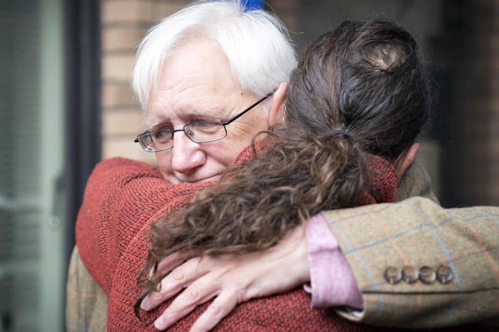 Craig Murrary says goodbye to one of his sons before handing himself over to police. Photo: DPA