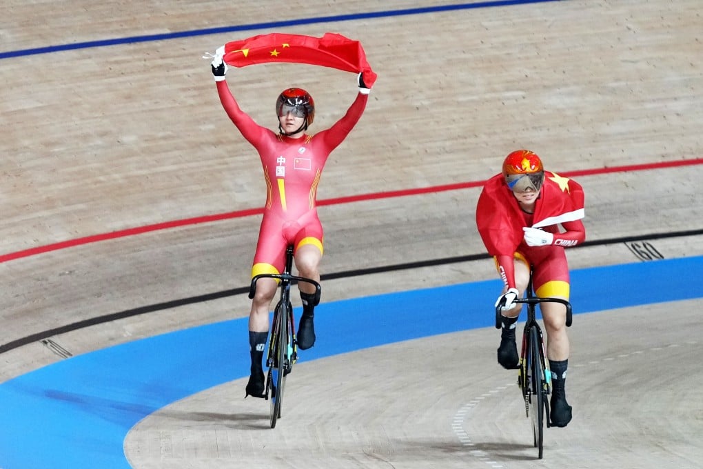 Chinese cyclists Zhong Tianshi (left) and Bao Shanju celebrate defending their Olympic title at Izu Velodrome. Photo: EPA